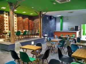 a restaurant with tables and chairs and green ceilings at Motion Chueca in Madrid