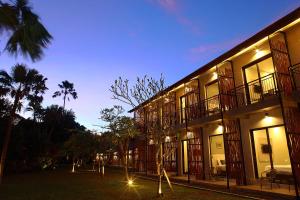 a building with a tree in front of it at Adys Inn in Legian