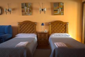 a bedroom with two beds and a blue couch at La Posada de Clotilde in Cella +31 photos