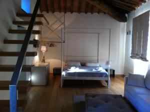 a bedroom with a bed and a staircase at Tuscany Meanders in Bagni di Lucca