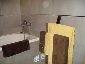 a bathroom with two towels and a bath tub at Stone House in Sabugueiro +73 photos