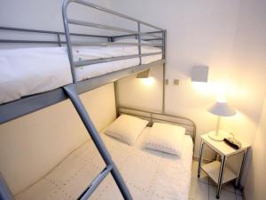 two bunk beds in a small room with a lamp at #Cannes Boccacabana Beach, Seafront, in Résid Pierre&Vacances 3 Stars in Cannes +48 photos