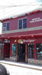 a red building with a store with a sign on it at Hostal Don Frank in San Carlos +24 photos