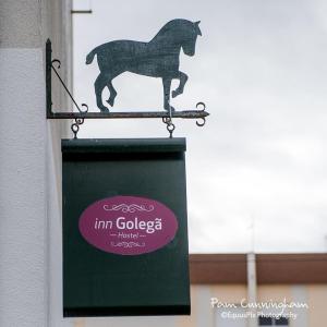 a sign with a horse on the side of a building at Inn Golegã in Golegã