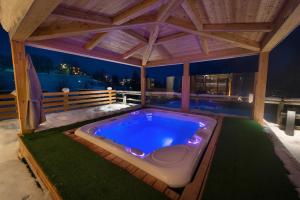 a hot tub in a gazebo on a patio at Hotel Cristallo in Peio Fonti