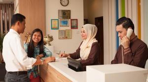 a group of people standing around a reception desk at Hotel Seri Malaysia Genting Highlands in Genting Highlands
