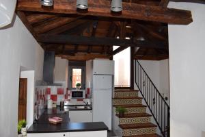 a kitchen with a staircase and a refrigerator in a room at Apartamento Mercedes in Cobisa +17 photos