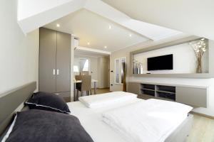 a bedroom with two beds and a flat screen tv at D&G Apartments Zagreb in Zagreb