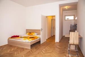 a bedroom with a bed and a room with a hallway at Beautiful Central Apartment Thámova in Prague