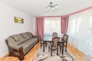 a living room with a couch and a table at Apartments Sonce in Truskavets