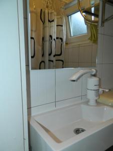 a bathroom with a sink and a mirror at Vacation Home Katarina in Čapljina +68 photos