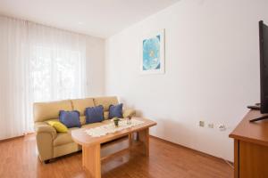 a living room with a couch and a coffee table at Guest House Croatia in Fažana