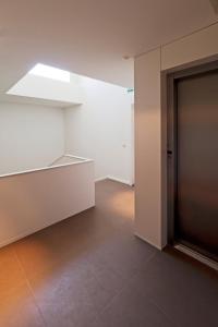a bathroom with a door open and a light on at bnapartments Palacio in Porto
