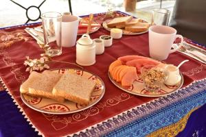 a table topped with plates of sandwiches and bread at Akumal Natura Glamping in Akumal