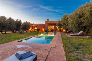 a swimming pool in the yard of a house at Villa Kristy in Marrakech