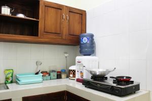 a kitchen counter with a stove with a bowl on it at House of Dharmawan in Surabaya