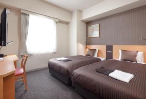 Postel nebo postele na pokoji v ubytování Hotel Super Tomari