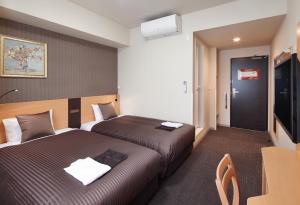 Postel nebo postele na pokoji v ubytování Hotel Super Tomari