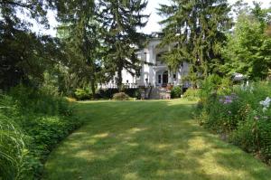 a large white house with a large yard at Albemarle Inn - Asheville in Asheville