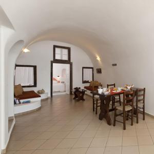 a living room with a table and a couch at Vallais Villa in Imerovigli