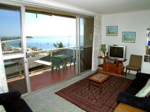 a living room with a view of the ocean at Blue Waters Unit 8 59 Ronald Avenue in Shoal Bay