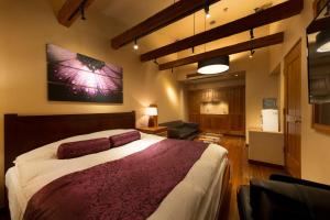 a bedroom with a large bed and a living room at Hotel Lotus Nara (Adult Only) in Nara