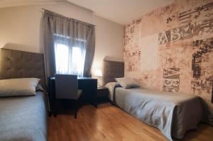 Voodi või voodid majutusasutuse Hotel Maloia toas