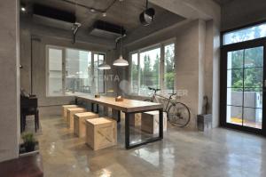 a room with a table and benches and a bike at Genuinn in Taitung City