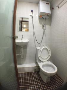 a small bathroom with a toilet and a sink at New Yan Yan Guest House reception 9th floor Flat E4 E6 in Hong Kong