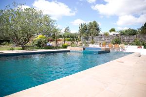 a swimming pool with blue water in a yard at Christofphs in Bonnievale