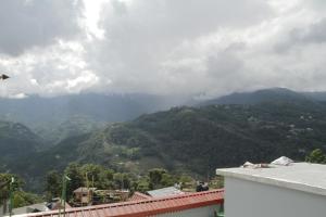 a view of a mountain range from a building at Twin Spring in Gangtok