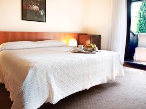 a bedroom with a large bed and a large window at Hotel Due Mori in Cittadella