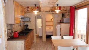 Küche und Essbereich eines winzigen Hauses in der Unterkunft La roulotte du bucheron in Lapoutroie