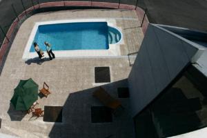 two people standing in front of a swimming pool at Puerta de Santillana in Reocín