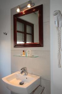 a bathroom with a sink and a mirror at Hostal Ripoll Ibiza in Ibiza Town