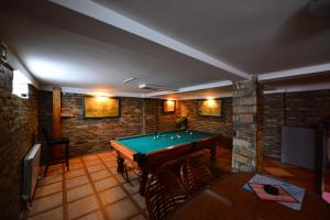 a room with a pool table in a room at Apartments & Accommodation Stojic in Novi Sad