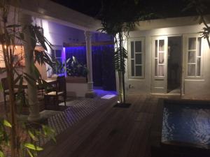 a house with a swimming pool at night at The Patio Yogya in Yogyakarta