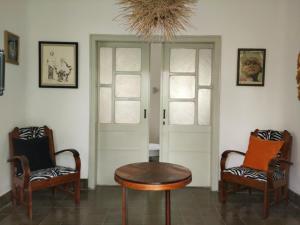 a room with two chairs and a table and a door at The Patio Yogya in Yogyakarta