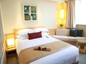 Postel nebo postele na pokoji v ubytování Jinglun Hotel Beijing