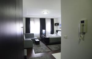 a hotel room with a bed and a chair at A blok apartments A1 in Belgrade