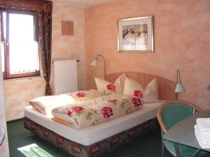 a bedroom with a bed with flowers on it at Hotel Sternen in Lenzkirch