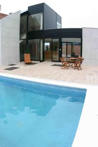 a swimming pool in front of a house at Puerta de Santillana in Reocín