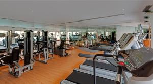 a gym with treadmills and elliptical machines at The Park Visakhapatnam in Visakhapatnam