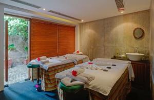 a group of four beds in a room at The Park Visakhapatnam in Visakhapatnam