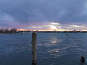 a wooden post in the middle of a body of water at Affittacamere Porticciolo in Castelnuovo del Garda