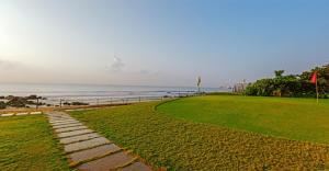 a pathway leading to the beach with the ocean in the background at The Park Visakhapatnam in Visakhapatnam