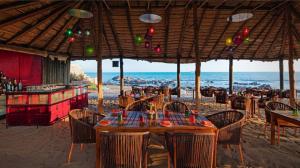 a restaurant on the beach with a table and chairs at The Park Visakhapatnam in Visakhapatnam