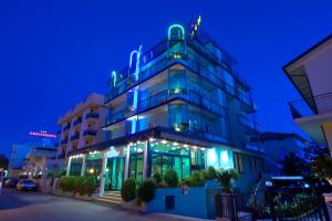 a building with blue lights on it at night at Hotel Hamilton in Misano Adriatico