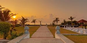 a pathway in a park with a sunset in the background at The Park Visakhapatnam in Visakhapatnam