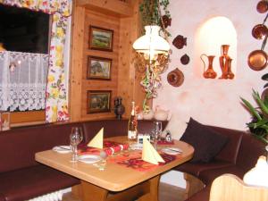 a dining room with a table and a couch at Hotel Sternen in Lenzkirch